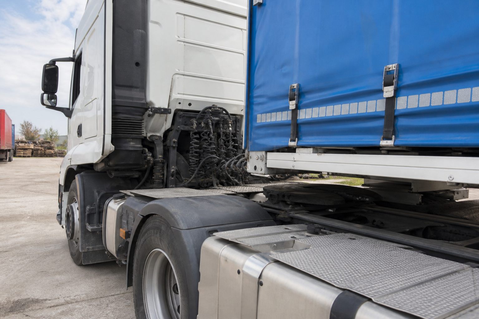 HGV tractor unit coupling to a semi-trailer at a depot